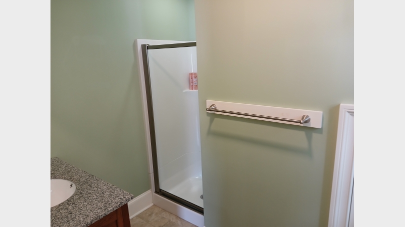 Visual of shower and vanity of mudroom bathroom