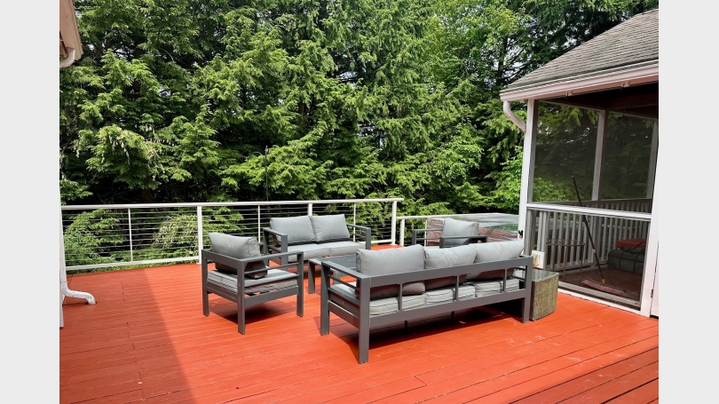 Deck next to screen porch and hot tub