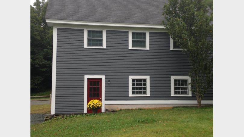 Side entrance to garage, laundry and interior stairs to apartment.
