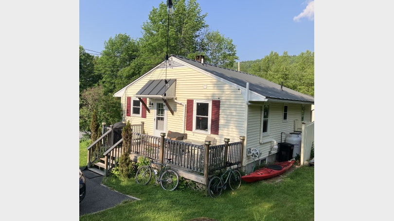 One story yellow house with porch