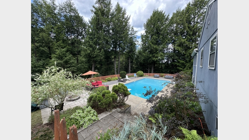 Pool and deck with fire pit landscaping
